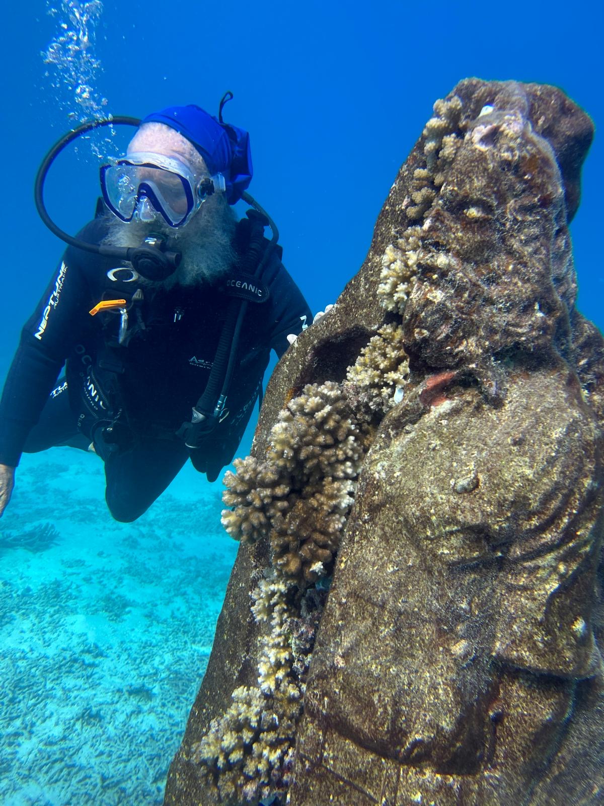Dr. Vaughan swimming with the underwater statue