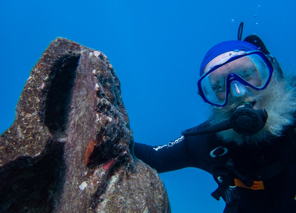 Dr. Vaughan swimming alongside the statue