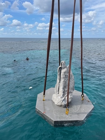 Lowering the statue into the ocean