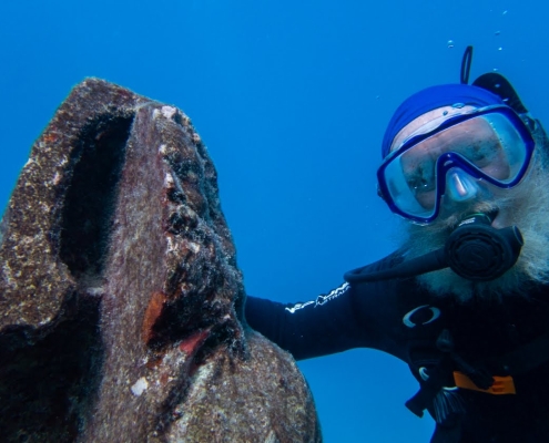 Dr. David Vaughan swimming with statue