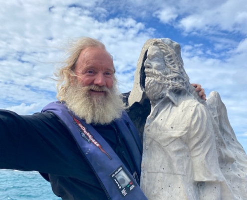 Dr. David Vaughan with statue