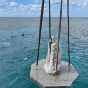 Statue being lowered into the ocean