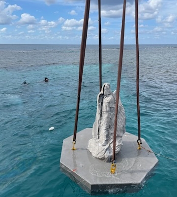 Statue being lowered into the ocean